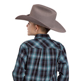 Back view of a boy wearing a teal and black large plaid long sleeve shirt