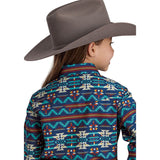 back view of a girl wearing a navy and rust colored aztec pring long sleeve shirt