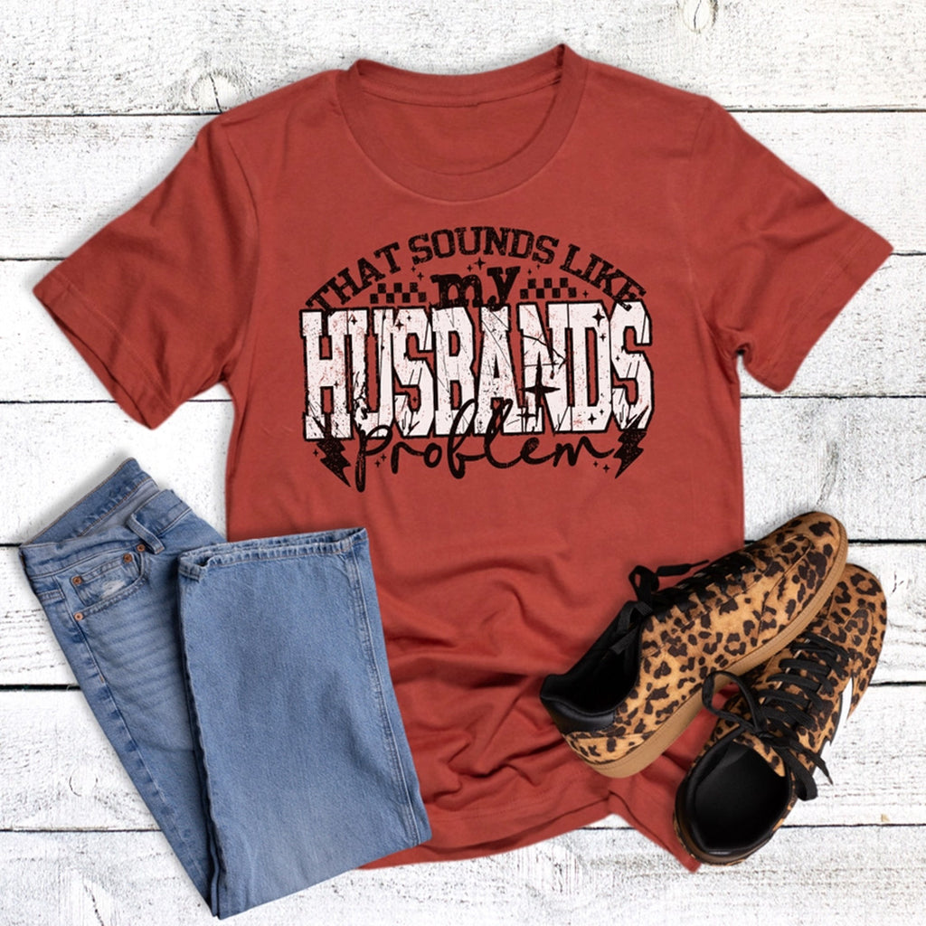 Red t-shirt with graphic text, blue jeans, and leopard print shoes