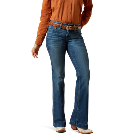 Person wearing blue jeans and an orange shirt on a white background