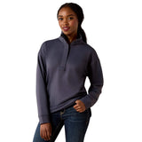 Woman wearing a dark ombre blue pullover with a quarter zip