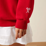 Close view of sleeve detail on the Ariat Red Rowdy Oversized Crew