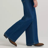 Walking view of the jeans, loose wide leg bottoms.