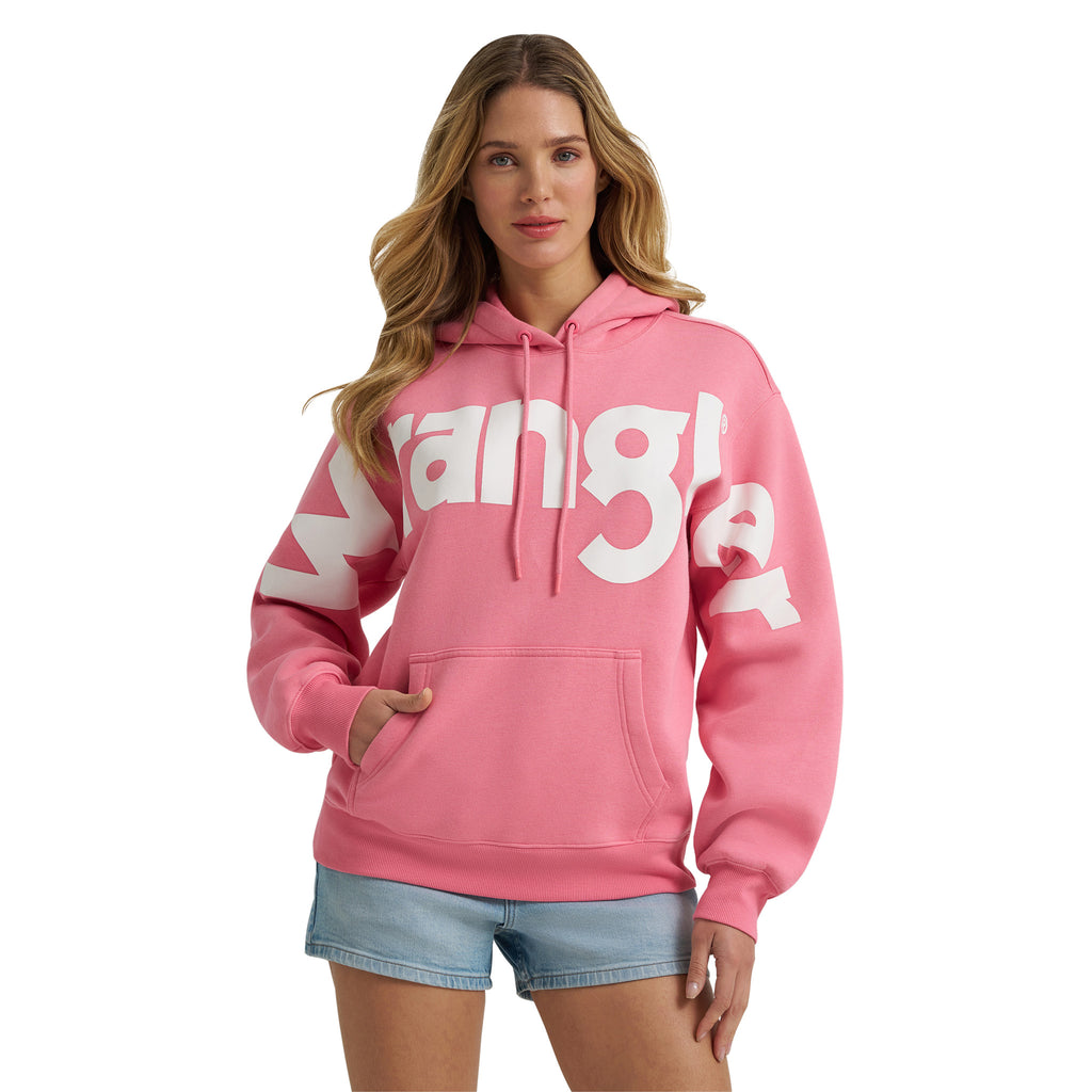 Model wearing the Women’s Wrangler Bold Logo Pink Hoodie with relaxed fit and fleece lining.