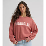 Model wearing the women’s Wrangler logo pullover crewneck, front view showing the bold Wrangler logo, soft fleece fabric, and relaxed Western fit.