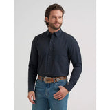 Model wearing the Wrangler Men’s Cody Johnson black spotted performance button down shirt, front view showing the button placket.