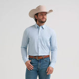 Model wearing the men’s Cody Johnson performance button down shirt in blue and white, front view showing the stretch fabric, button placket, and Western yokes.