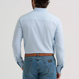 Back view of a model wearing the men’s Cody Johnson performance blue and white button-down shirt, showing the Western back yoke, smooth performance fabric, and clean fit.