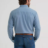 Back view of a model wearing the Wrangler Cody Johnson performance button down shirt.