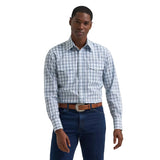 Model wearing the men’s wrinkle resist long sleeve Western snap plaid shirt in white and grey, front view showing the plaid pattern, pearl snaps, and classic Western yokes.