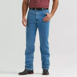 Model wearing Wrangler Tough Lite faded stone jeans, front view showing the lightweight denim, relaxed Western fit, and faded stone wash.