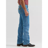 Side view of a model in Wrangler Tough Lite faded stone jeans, highlighting the straight‑leg profile, durable lightweight fabric, and work‑ready fit.