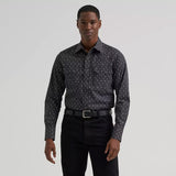 Model wearing the Men’s Wrangler Retro long sleeve sawtooth snap pocket Western shirt, front view showing the pointed yokes, sawtooth pockets, and pearl snaps.