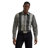 Model wearing the Wrangler men’s black and gray Brushpopper long sleeve Western shirt, front view showing the bold stripe pattern, pearl snaps, and classic fit.