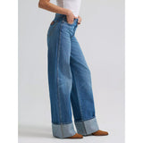 Side view of a model in the Wrangler Bailey wide leg cuffed jean, highlighting the high‑rise fit, relaxed wide leg, and clean cuff detail.