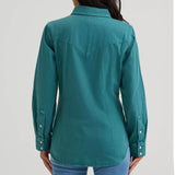 Back view of a model wearing the Wrangler Retro turquoise long sleeve shirt, showing the Western back yoke, smooth fabric drape, and clean, flattering fit.