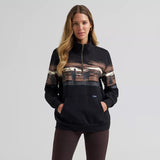 Model wearing the Wrangler Women’s Wild West 1/4 zip pullover, front view showing the soft fleece texture, quarter‑zip neckline, and relaxed Western fit.