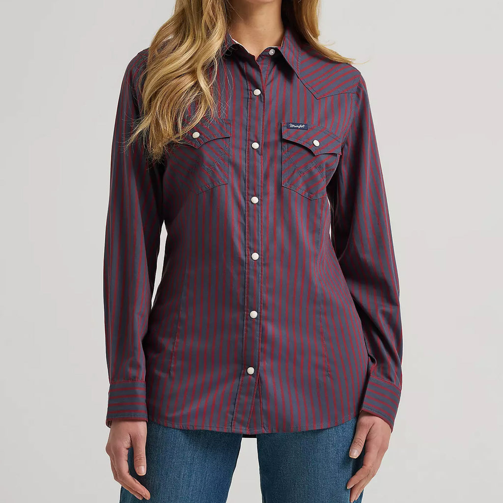 Model wearing the Wrangler women’s burgundy retro stripe long sleeve Western shirt, front view showing the snap placket, stripe pattern, and slim Western fit.