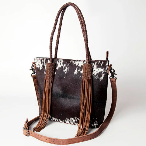 Front side view of cowhide fringe purse. 