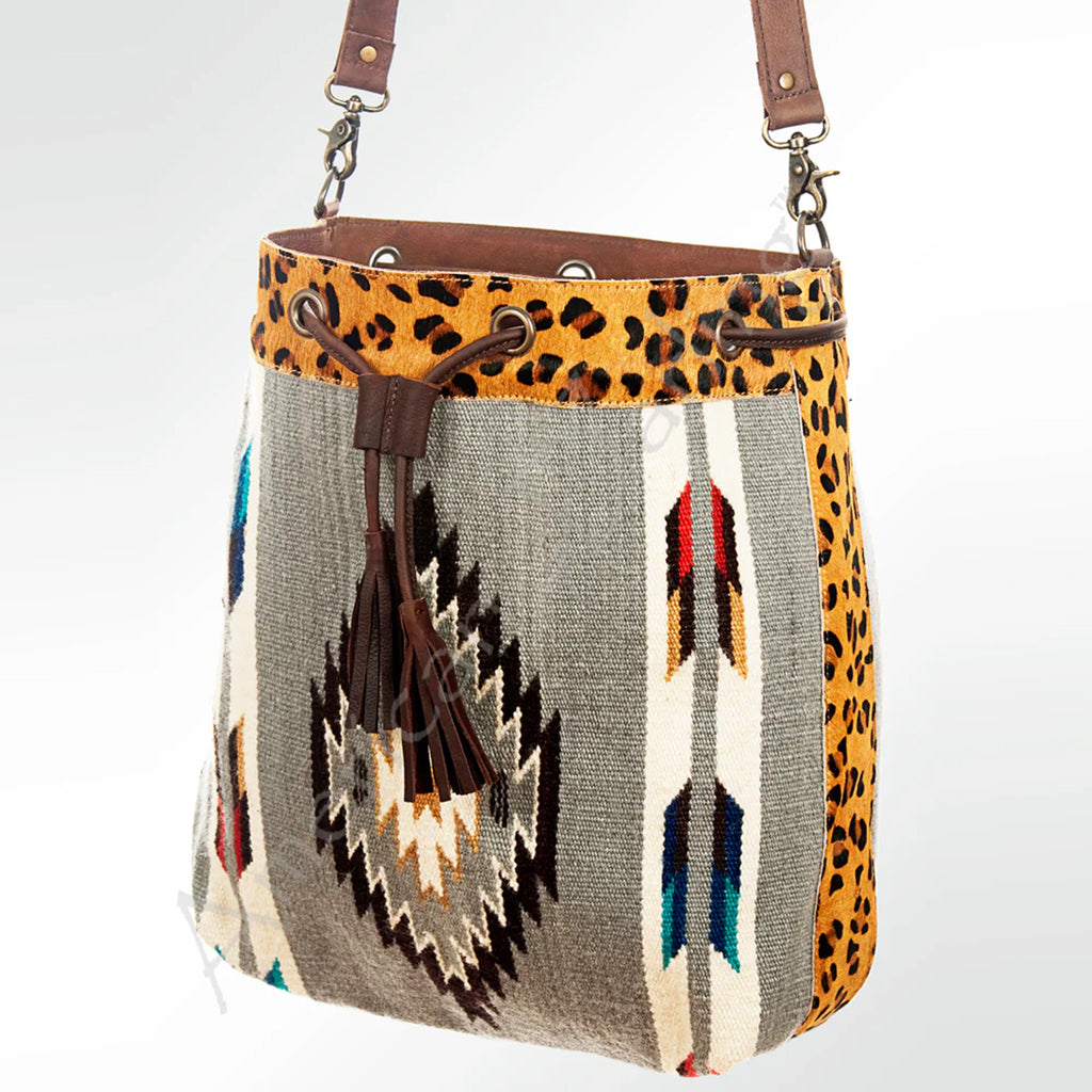 Blanket purse with cheetah print on the edges. Blanket is grey with an Aztec design in the middle and arrow designs on the side. 