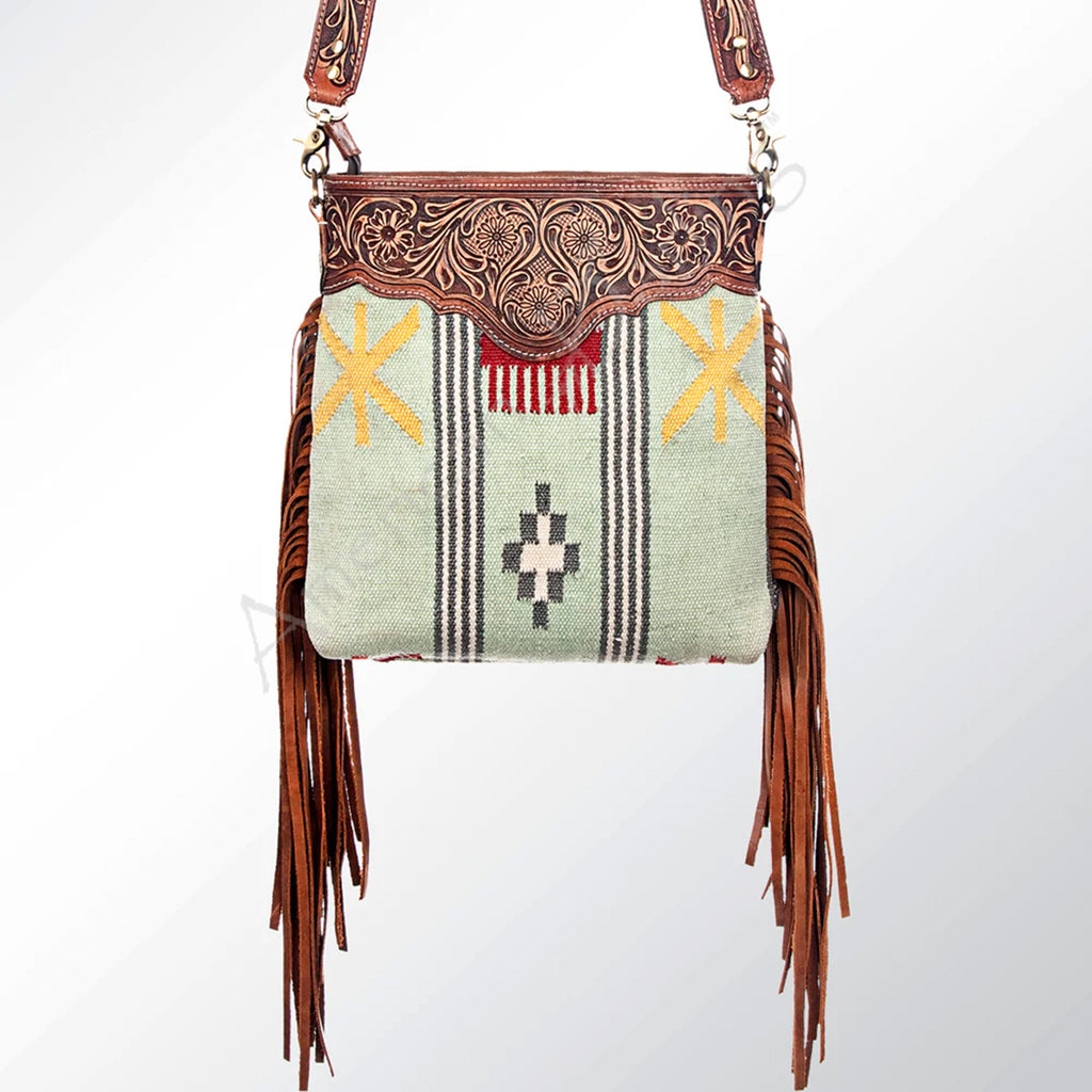 L8ight green blanket purse with tooled leather at the top and fringe on the sides. 
