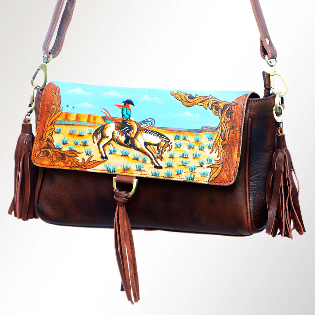 Leather purse with painted desert bronc scene. Purse also features small fringe keychains. 