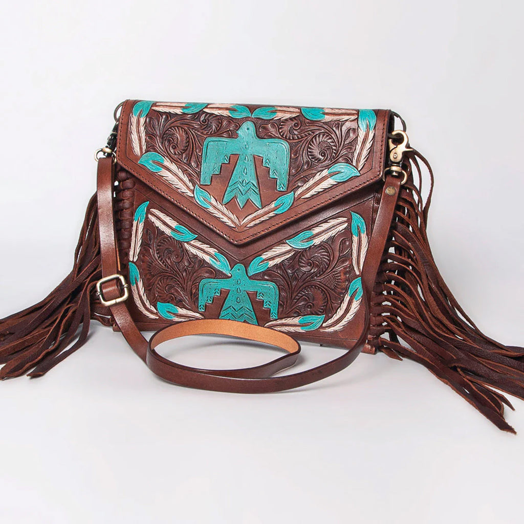 Dark brown leather envelope style purse with tooled thunderbird designs and fringe. 
