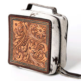 Front of the case, top has brown leather tooling with turquoise painted accents. Case has black and white cowhide on the sides and a handle on top.