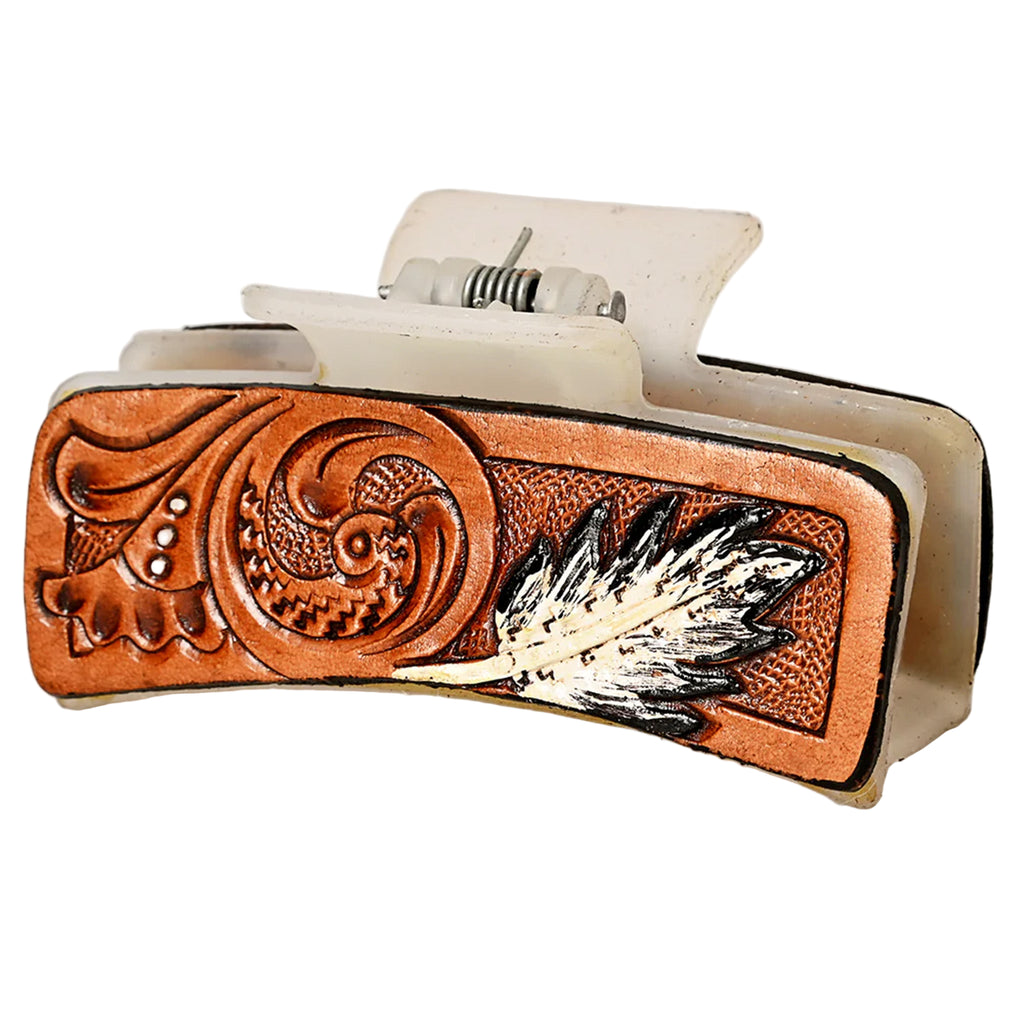 White acrylic hair clip with a tooled leather panel with a feather. 