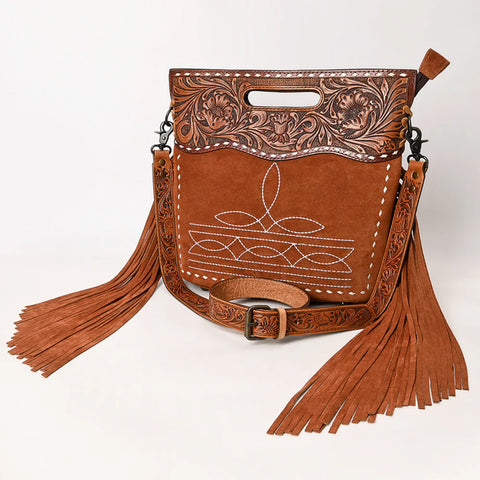 Tan Shoulder Bag with white boot stitch embroidery. Hand tooled floral top with cut out hand hold and matching leather buckled strap. Fringe leather pieces on the sides. 
