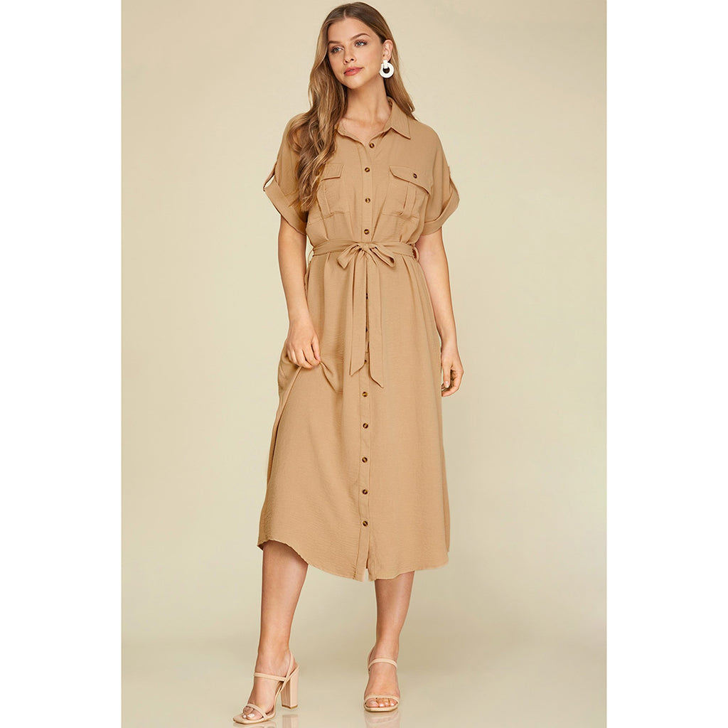 This dress features a button down design with a unique folded neckline and drop shoulder, complete with a convenient flap pocket