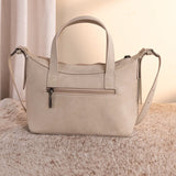 Back side of Wrangler Beige Tooled Aztec Print Crossbody Bag