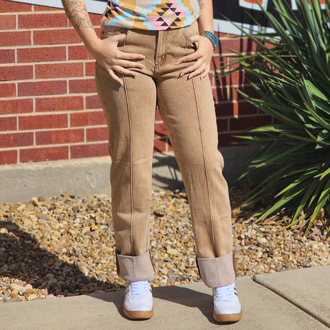 buckskin colored jeans that are mid rise cuffed at the bottom and have front seem down the front of the jean