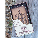 Brown roughout wallet with a boot stitch design in the center in chocolate thread. White diamond lacing