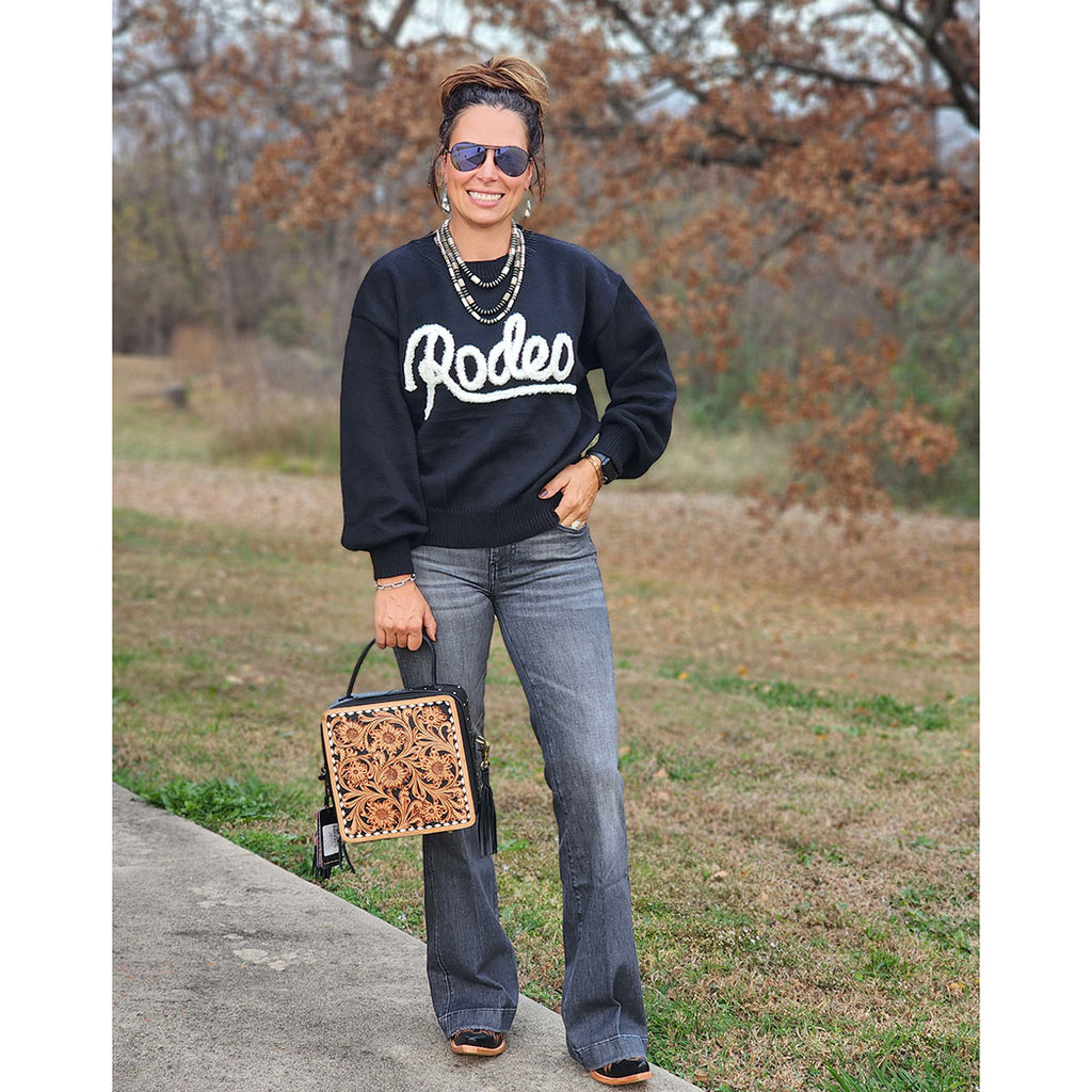 Woman wearing a black 'Rodeo' sweatshirt