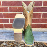 Bottom of hybrid boot sole next to green carpincho boot with tan top in front of brick background.