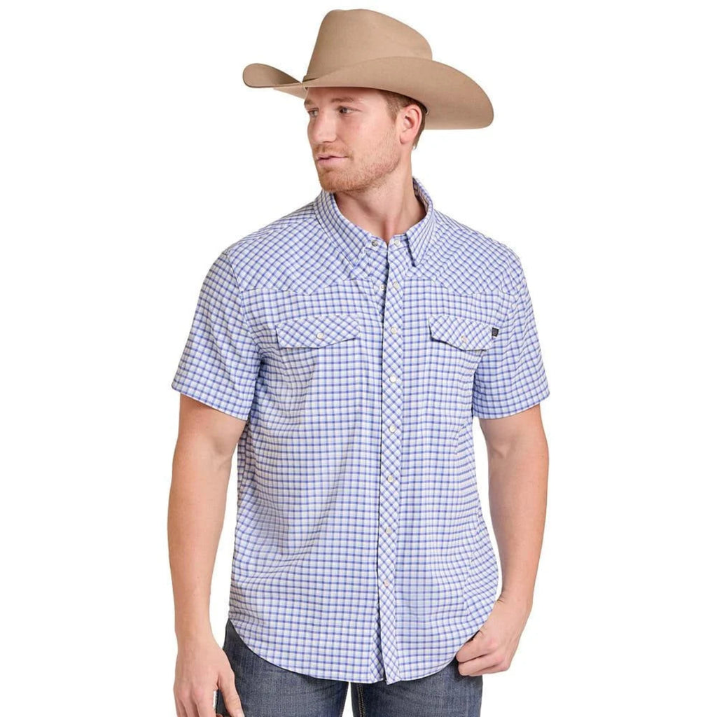 Model wearing a blue and white checkered short-sleeve Western shirt with snap buttons and dual chest pockets.