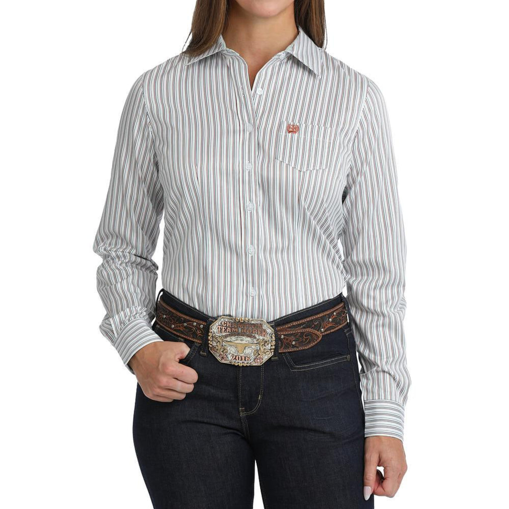 Woman wearing a white striped long-sleeve western shirt with a chest pocket and button closure.