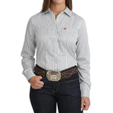 Woman wearing a white striped long-sleeve western shirt with a chest pocket and button closure.