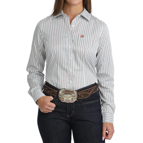 Woman wearing a white striped long-sleeve western shirt with a chest pocket and button closure.