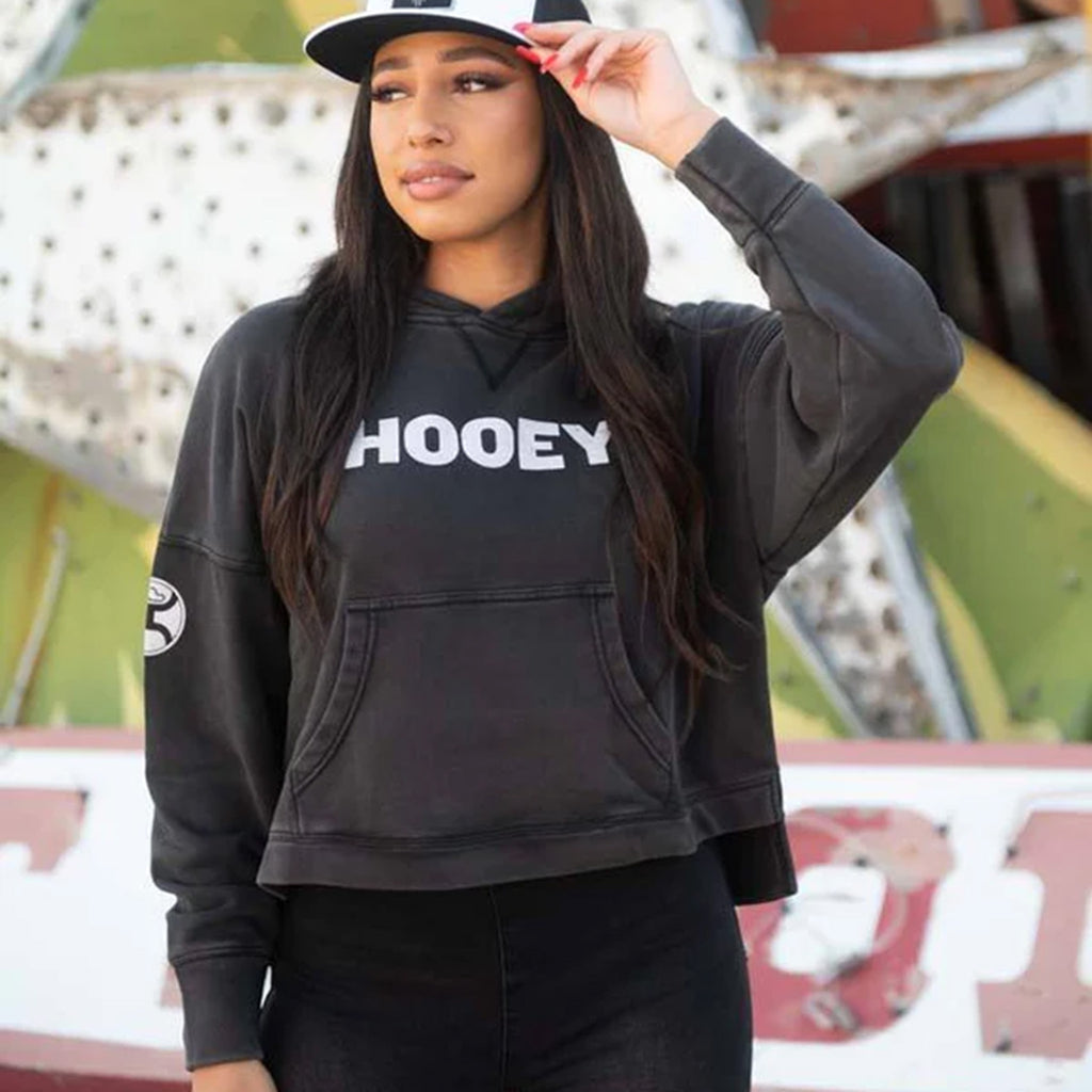 Model wearing the Hooey Roomy Black Hoody, standing front‑facing to show the relaxed fit and Western‑casual style.