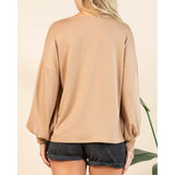 Back view of a female model wearing the mocha long sleeve shirt.
