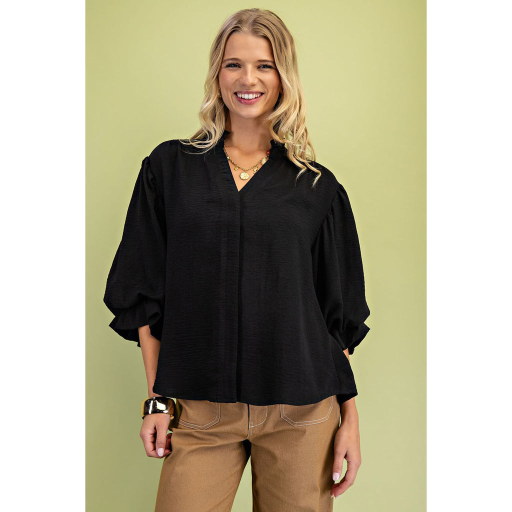 Model wearing the black 3/4 balloon sleeve blouse, front view showing the voluminous sleeves, flattering silhouette, and polished, versatile style.