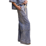 Side view of model wearing Wide‑Leg Denim Drawstring Pants showing wide‑leg shape and side pocket