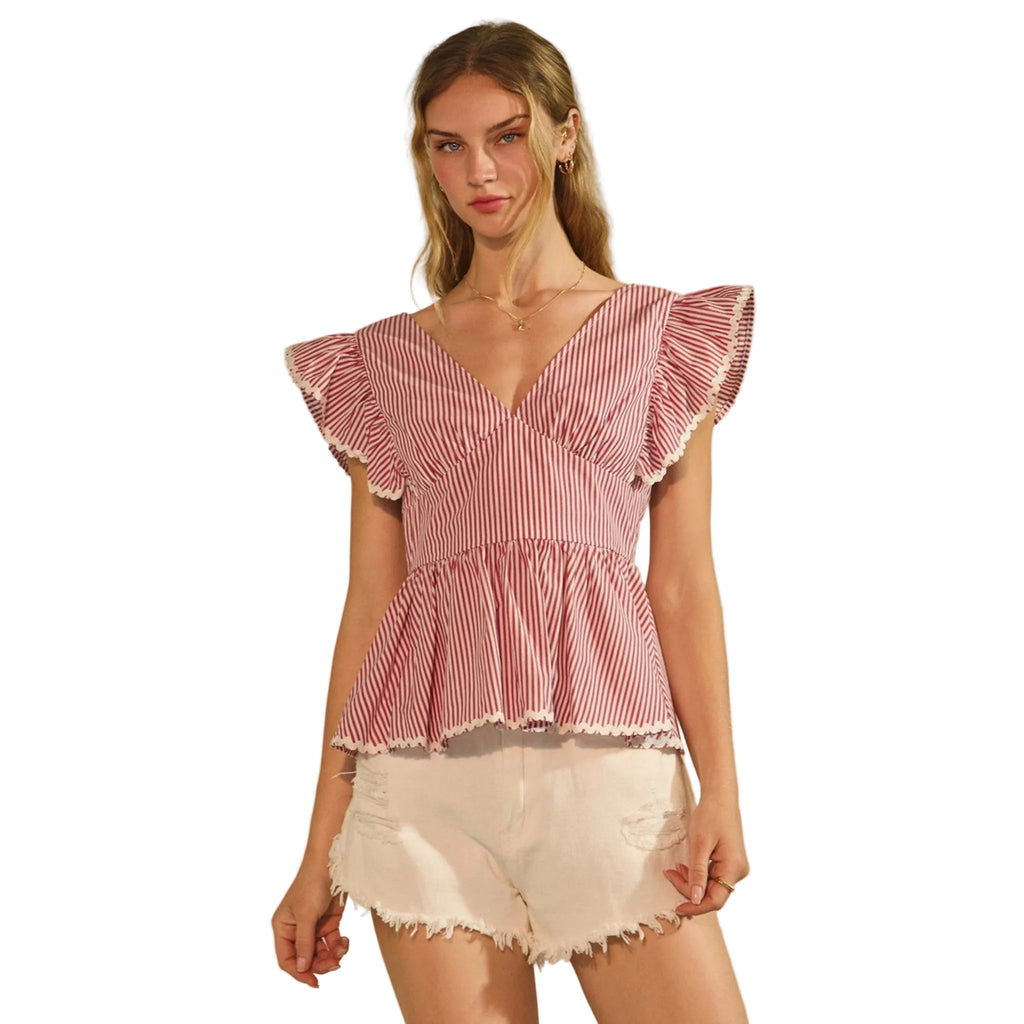 Woman wearing a red and white striped top with ruffled sleeves 