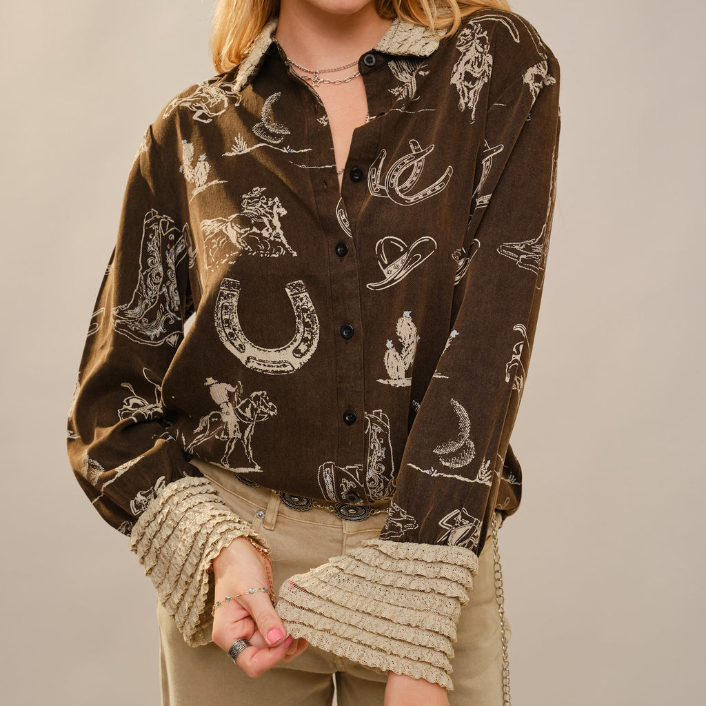 Long sleeve dark brown button up with light brown horse shoe, hats, cowboys, and boots designs, Sleeve cuffs and collar have light brown ruffles.