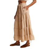 Side view of model in a tiered maxi skirt highlighting the soft movement, tiered layers, and pocket.
