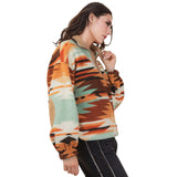 Side view of the model wearing the Mint and Orange Aztec Fleece 1/4 Zip, highlighting the elbow patch