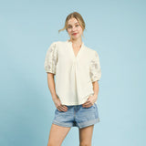 Woman wearing the Cream Flower Lace Sleeve Blouse, front view showing the floral lace sleeves and cream bodice