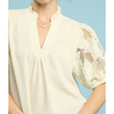 Close‑up of model wearing the Cream Flower Lace Sleeve Blouse, focusing on the floral lace sleeve texture 